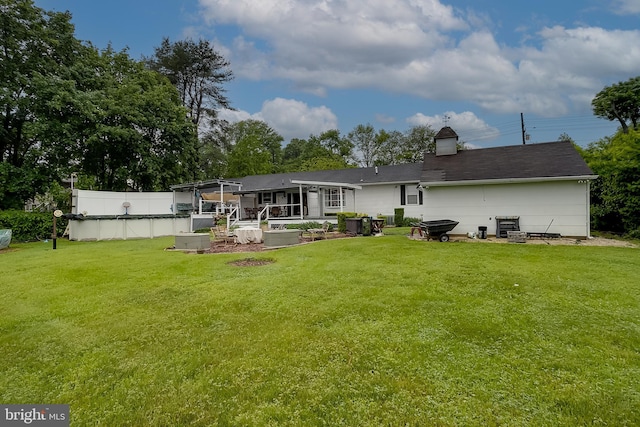 2066 Old York Rd, Burlington, NJ 08016 - back of property with a yard, a patio area, and a chimney