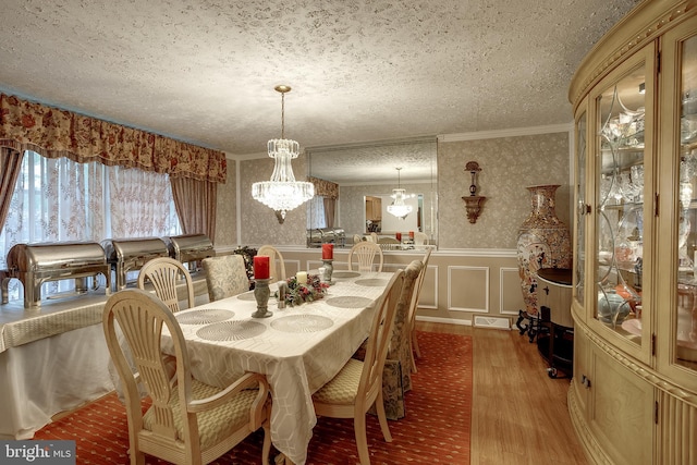 2066 Old York Rd, Burlington, NJ 08016 - dining room featuring wood finished floors, ornamental molding, a textured ceiling, wainscoting, and a chandelier