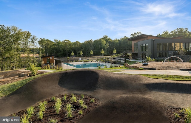 view of pool with a fenced in pool and fence