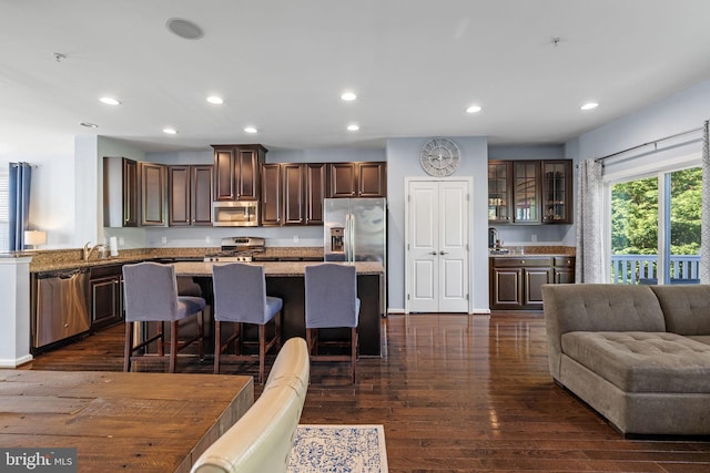 274 Macdonald Ave Unit 22, Wyncote, PA 19095 - kitchen with dark wood-style flooring, a kitchen bar, a center island, stainless steel appliances, and recessed lighting
