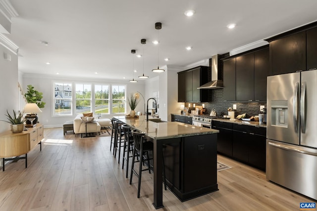 43 Farrow Cir, Charlottesville, VA 22901 - kitchen featuring a sink, a breakfast bar area, stainless steel appliances, a center island with sink, and wall chimney exhaust hood