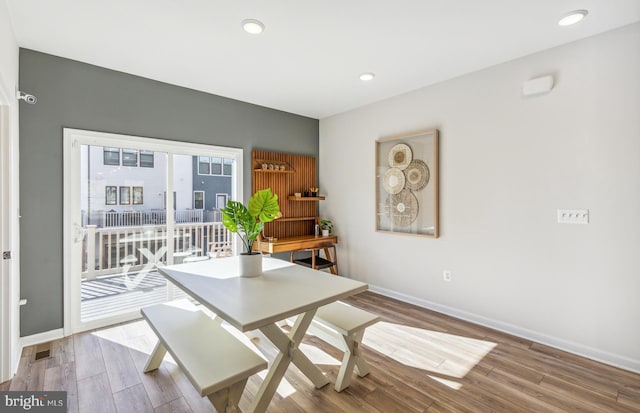 dining space with visible vents, baseboards, wood finished floors, and recessed lighting