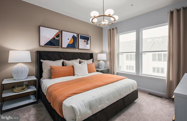 carpeted bedroom featuring baseboards, visible vents, a notable chandelier, and multiple windows