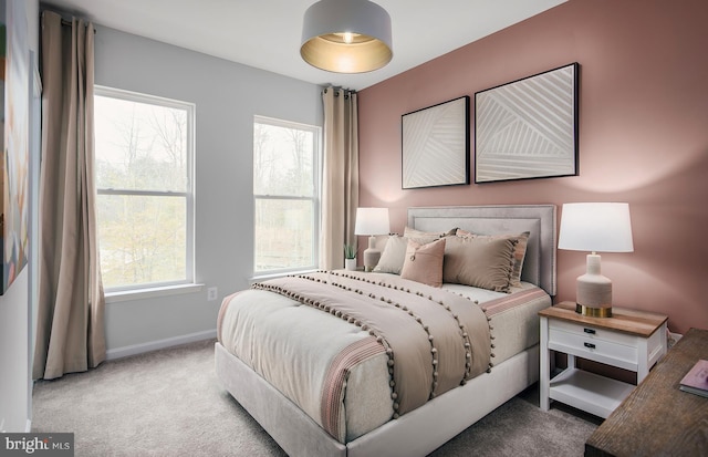 carpeted bedroom featuring baseboards