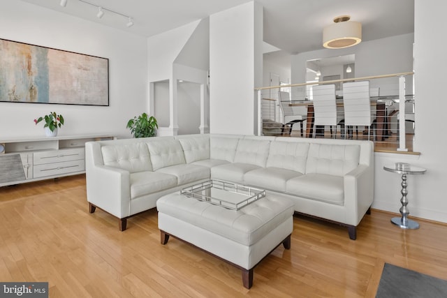 10323 Wilde Lake Ter, Columbia, MD 21044 - living area with light wood-style flooring, rail lighting, and baseboards