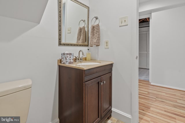 10323 Wilde Lake Ter, Columbia, MD 21044 - bathroom featuring vanity, wood finished floors, baseboards, and toilet