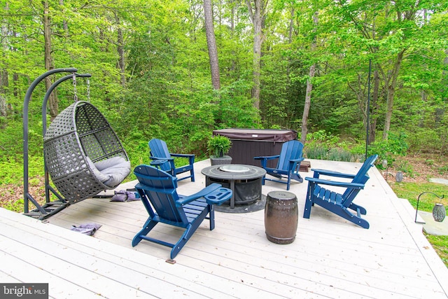 wooden terrace with a hot tub, a patio, and a fire pit