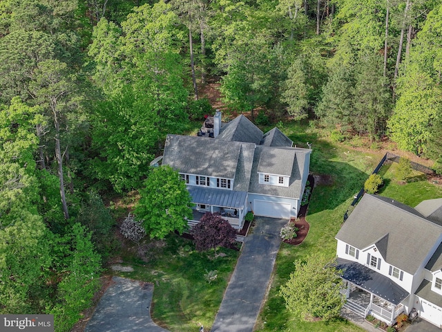 birds eye view of property with a view of trees