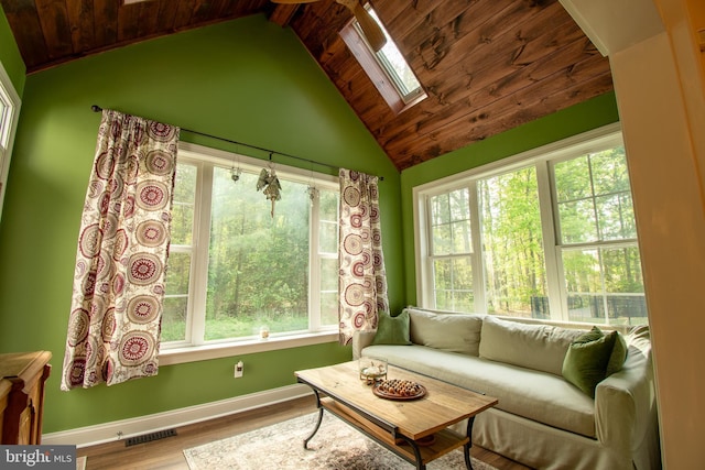 sunroom featuring a skylight, visible vents, and a wealth of natural light