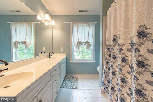 bathroom featuring toilet, visible vents, a sink, and tile patterned flooring