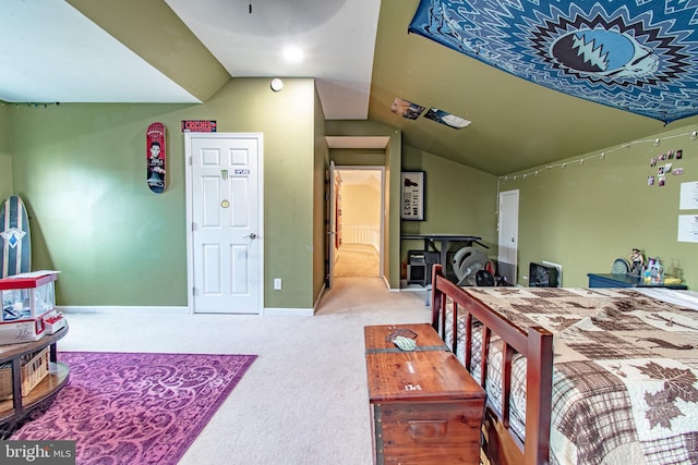 bedroom featuring baseboards, carpet, and lofted ceiling