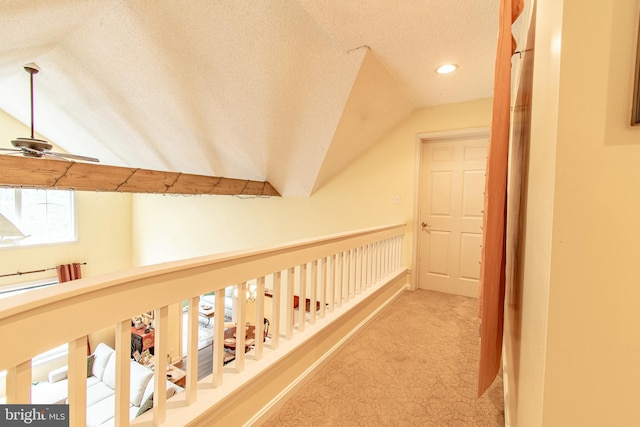 corridor featuring recessed lighting, a textured ceiling, carpet, and lofted ceiling
