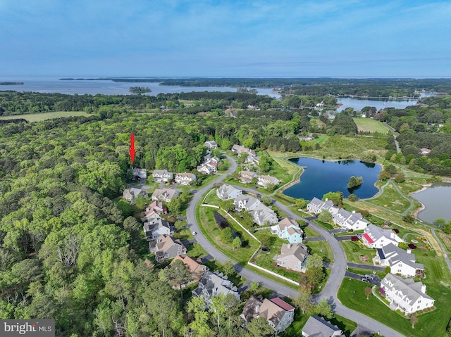 aerial view with a residential view, a view of trees, and a water view