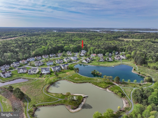 aerial view featuring a water view, a residential view, and a wooded view