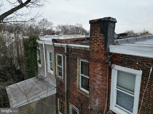 534 N Hobart St, Philadelphia, PA 19131 - view of home's exterior featuring brick siding and a chimney