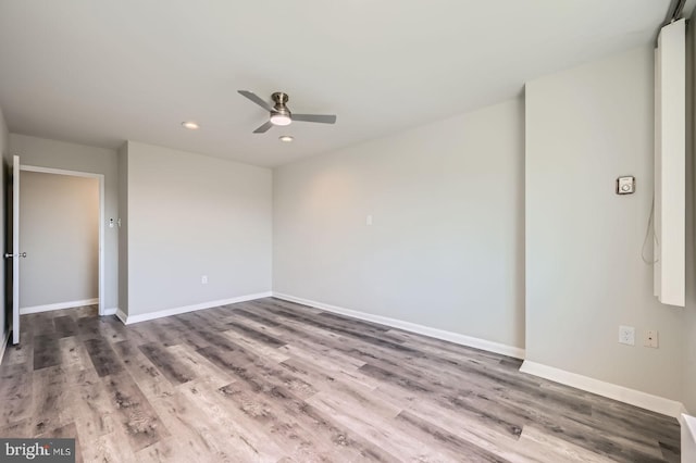unfurnished room featuring ceiling fan, baseboards, wood finished floors, and recessed lighting