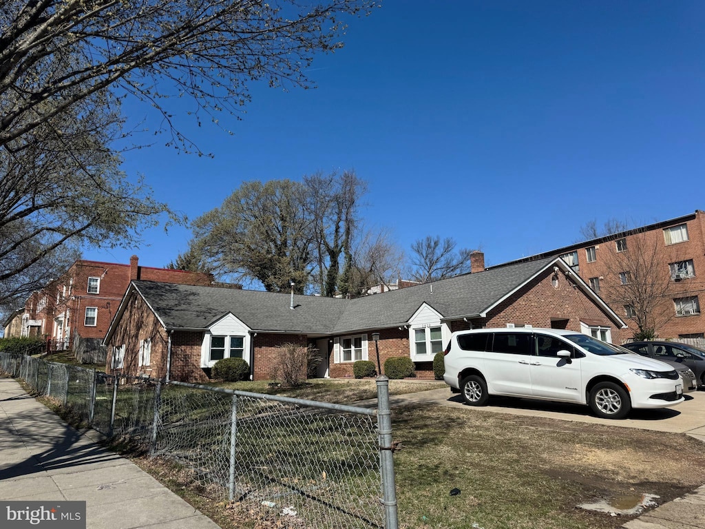 view of front of property featuring fence private yard and brick siding