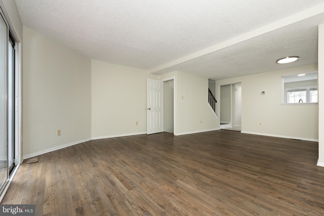 19320 Liberty Heights Ln, Germantown, MD 20874 - unfurnished living room with stairway, dark wood-type flooring, and a textured ceiling