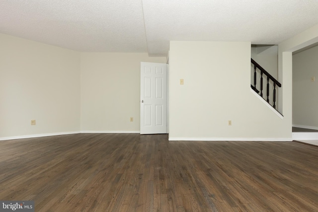 19320 Liberty Heights Ln, Germantown, MD 20874 - spare room featuring stairs, dark wood-type flooring, and a textured ceiling