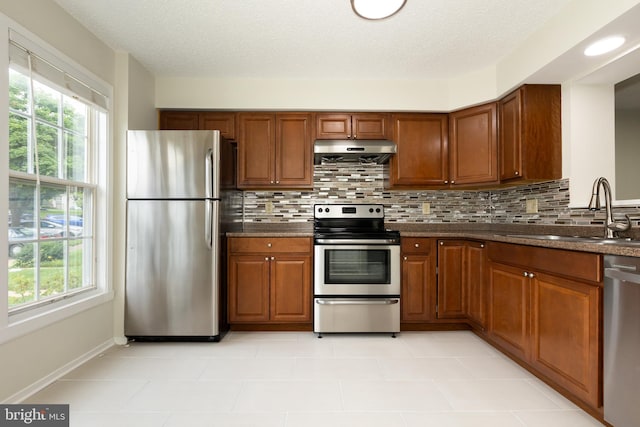 19320 Liberty Heights Ln, Germantown, MD 20874 - kitchen featuring stainless steel appliances, extractor fan, dark countertops, and plenty of natural light
