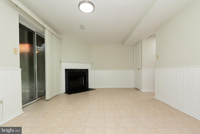 19320 Liberty Heights Ln, Germantown, MD 20874 - unfurnished living room with a wainscoted wall, a fireplace with flush hearth, and light tile patterned floors