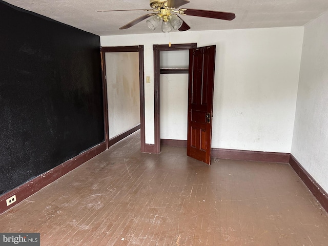 unfurnished bedroom with baseboards and a ceiling fan