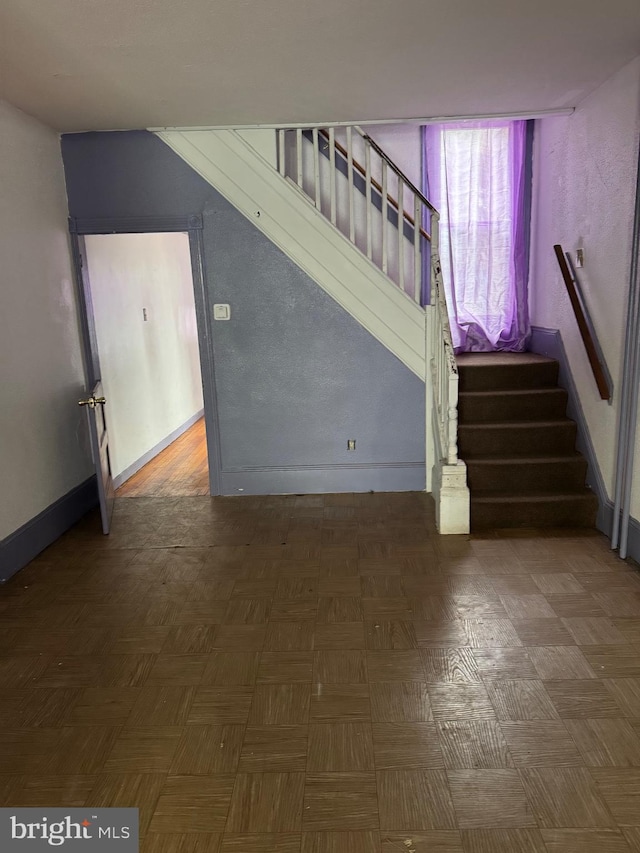 stairway featuring baseboards