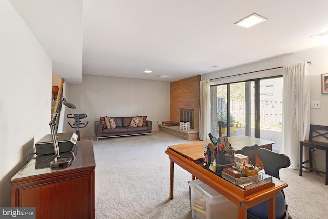 living room featuring a brick fireplace and carpet
