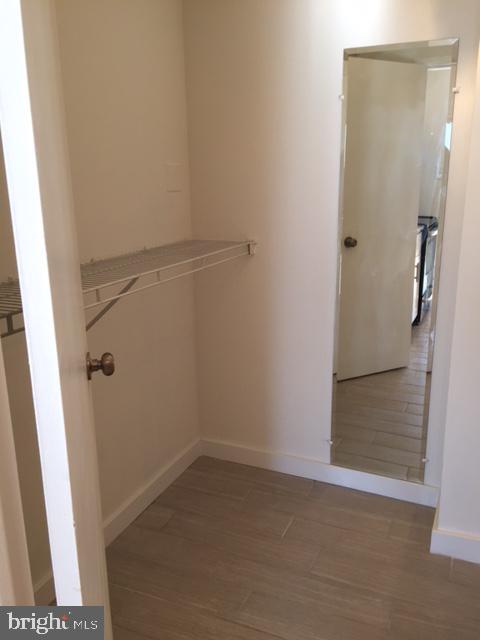 224 W Rittenhouse Sq Unit 2015B, Philadelphia, PA 19103 - walk in closet featuring wood finished floors