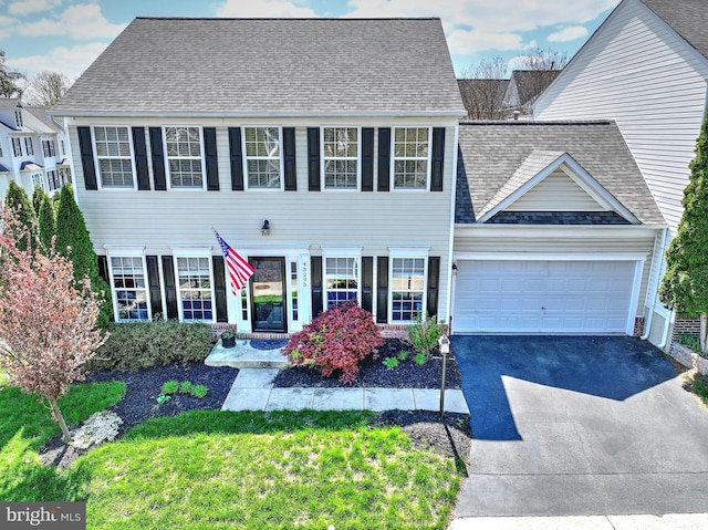 43295 Ardmore St, Ashburn, VA 20147 - colonial-style house featuring a garage, roof with shingles, and aphalt driveway
