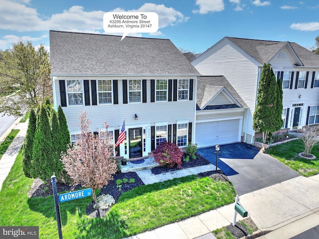 43295 Ardmore St, Ashburn, VA 20147 - colonial-style house featuring a shingled roof, an attached garage, driveway, and a front yard