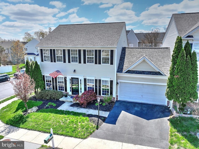43295 Ardmore St, Ashburn, VA 20147 - colonial inspired home featuring a garage, driveway, roof with shingles, and a front yard