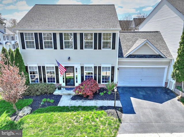43295 Ardmore St, Ashburn, VA 20147 - colonial inspired home with a garage, a shingled roof, a front lawn, and aphalt driveway