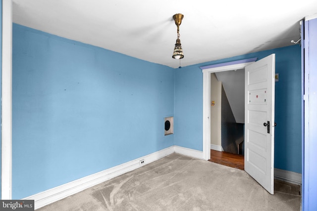 unfurnished room with carpet floors and baseboards