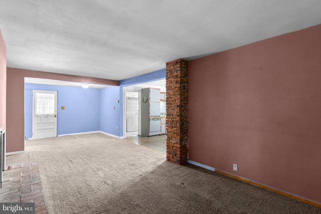 empty room with baseboards and carpet flooring