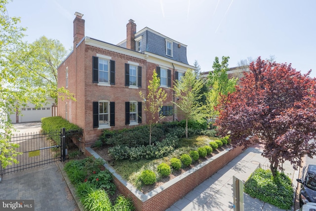 700 6th St SE, Washington, DC 20003 - view of property exterior with a gate, fence, a high end roof, mansard roof, and brick siding