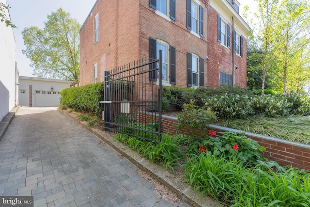 700 6th St SE, Washington, DC 20003 - view of property exterior with brick siding, a garage, and fence