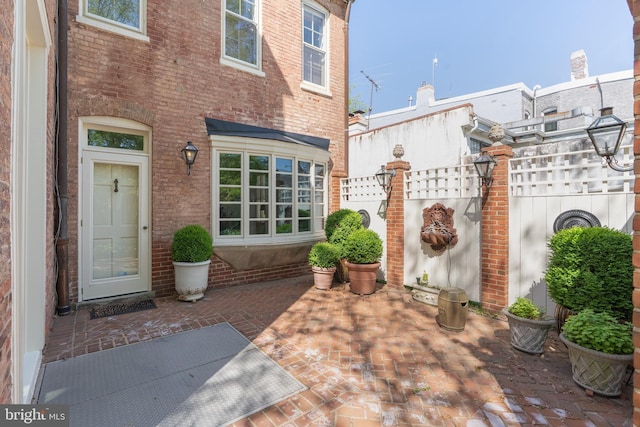 700 6th St SE, Washington, DC 20003 - property entrance with fence, a patio area, and brick siding