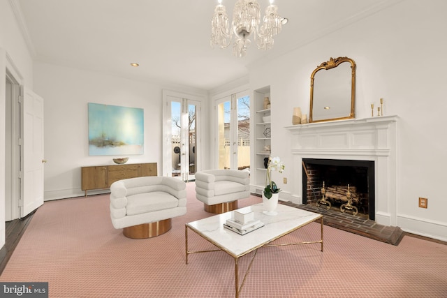 700 6th St SE, Washington, DC 20003 - living room featuring a fireplace with raised hearth, built in features, baseboards, and a notable chandelier