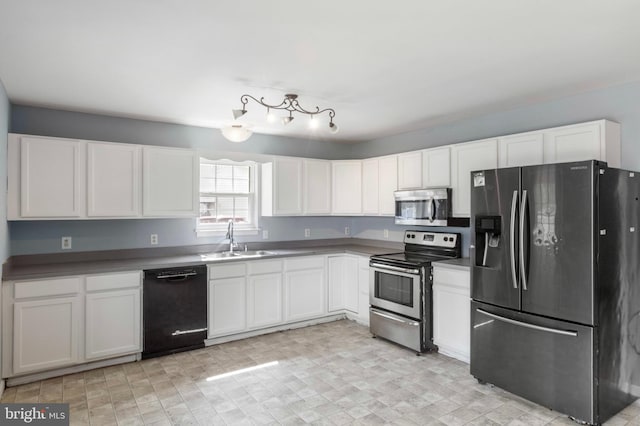 21 Thorn St, Magnolia, DE 19962 - kitchen with a sink, white cabinets, and appliances with stainless steel finishes