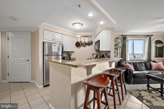 4201 Coastal Hwy Unit 116, Ocean City, MD 21842 - kitchen with a peninsula, ornamental molding, stainless steel appliances, and light tile patterned floors