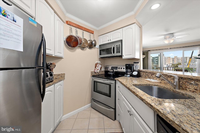4201 Coastal Hwy Unit 116, Ocean City, MD 21842 - kitchen with white cabinets, light tile patterned floors, a sink, stone counters, and appliances with stainless steel finishes