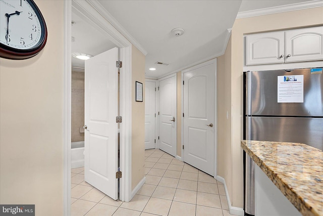 4201 Coastal Hwy Unit 116, Ocean City, MD 21842 - kitchen featuring crown molding, baseboards, freestanding refrigerator, and light tile patterned flooring