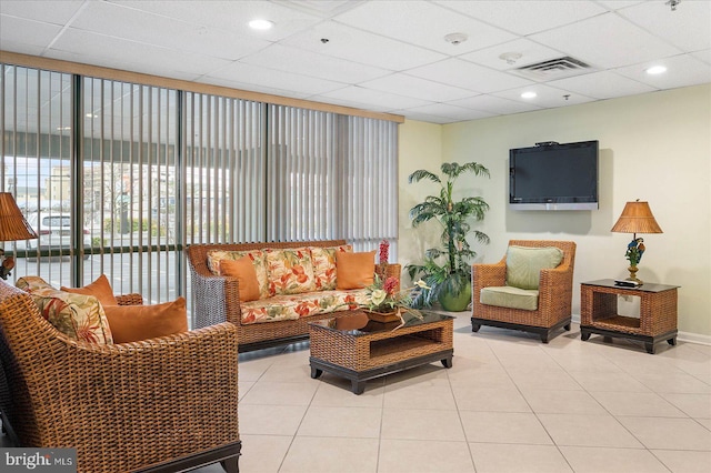 4201 Coastal Hwy Unit 116, Ocean City, MD 21842 - living room featuring baseboards, visible vents, light tile patterned floors, and a drop ceiling