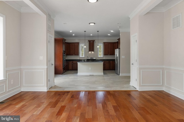 12304 Popes Head Rd, Fairfax, VA 22030 - kitchen featuring stainless steel appliances, open floor plan, dark countertops, visible vents, and a decorative wall