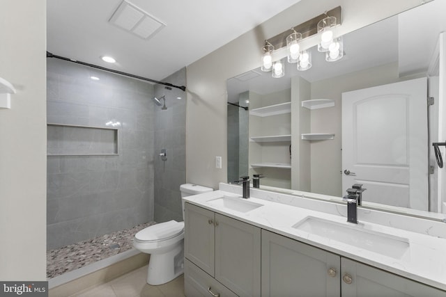 12304 Popes Head Rd, Fairfax, VA 22030 - full bathroom featuring a sink, toilet, tile patterned flooring, visible vents, and tiled shower