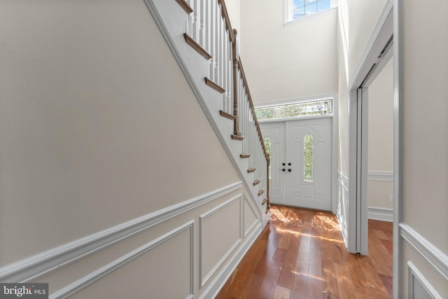 12304 Popes Head Rd, Fairfax, VA 22030 - foyer entrance with wood-type flooring, a towering ceiling, and stairs