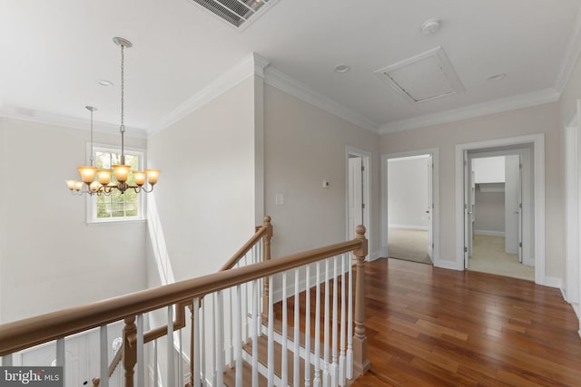 12304 Popes Head Rd, Fairfax, VA 22030 - corridor featuring an inviting chandelier, visible vents, an upstairs landing, wood-type flooring, and crown molding