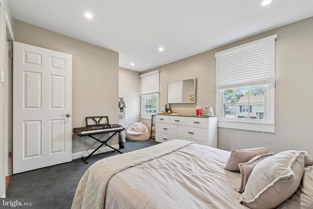 bedroom with baseboards, dark colored carpet, and recessed lighting
