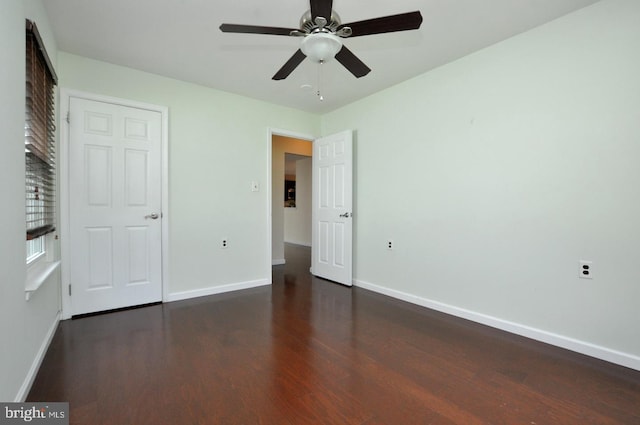 unfurnished bedroom featuring baseboards, a ceiling fan, and wood finished floors